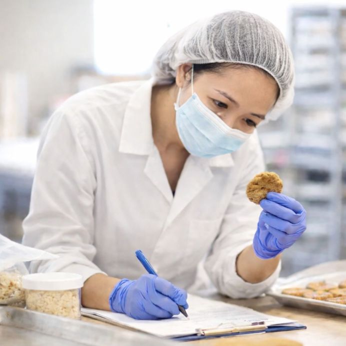 Food technologist evaluating a cookie sample in the lab